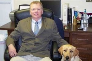 Photo of attorney David R. Thomas with dog